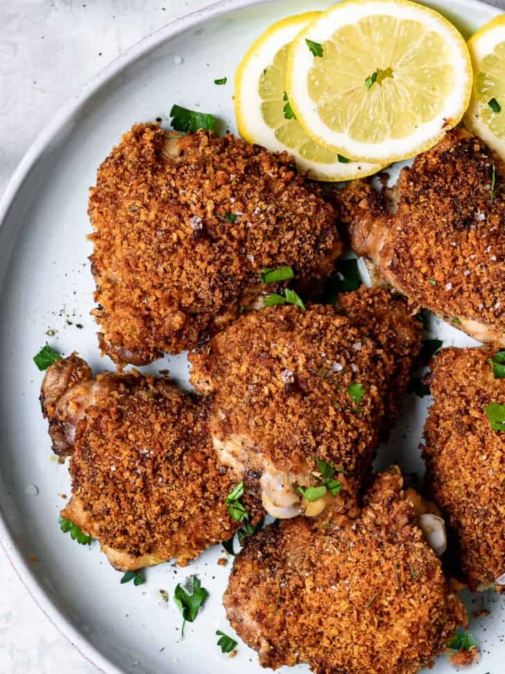 close up of crispy baked chicken thighs on plate 