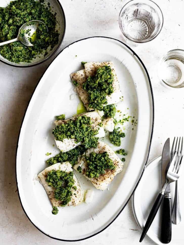 baked cod with Italian salsa Verde on platter