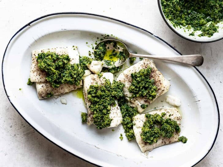 Baked Cod with Italian salsa verde served on platter