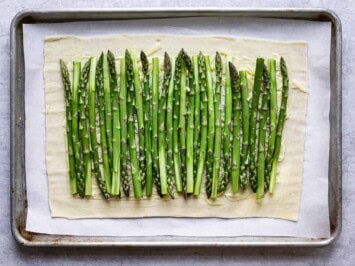 asparagus laid evenly on grated cheese