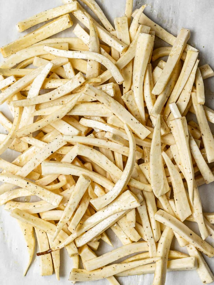 parsnip sticks on baking sheet tossed with olive oil 