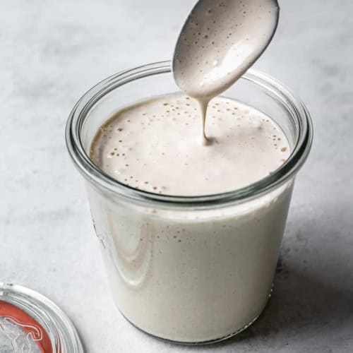 spoon dripping tahini dressing
