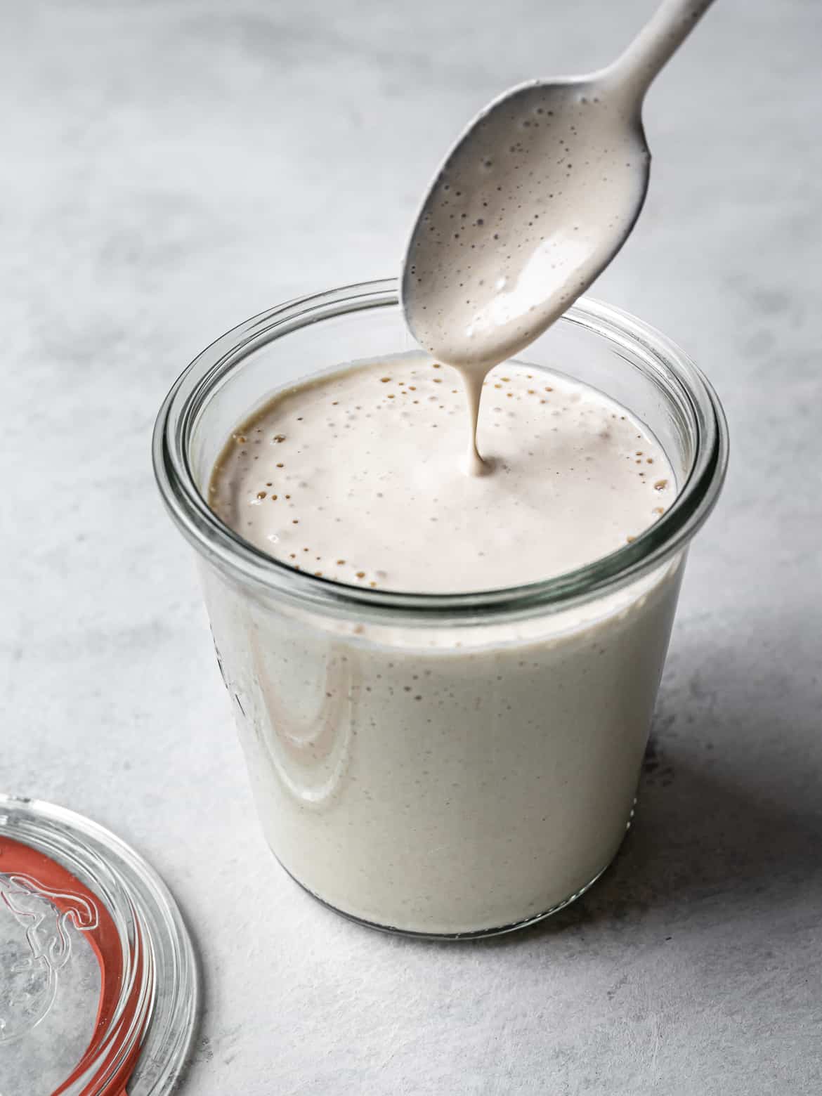 spoon dripping tahini dressing