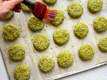 brushing oil on the top of falafel patty