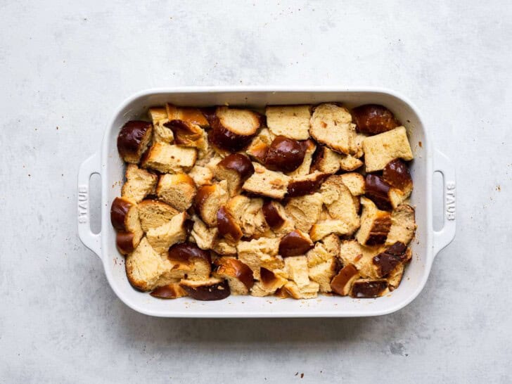 Cubed bread in baking dish with egg mixture 