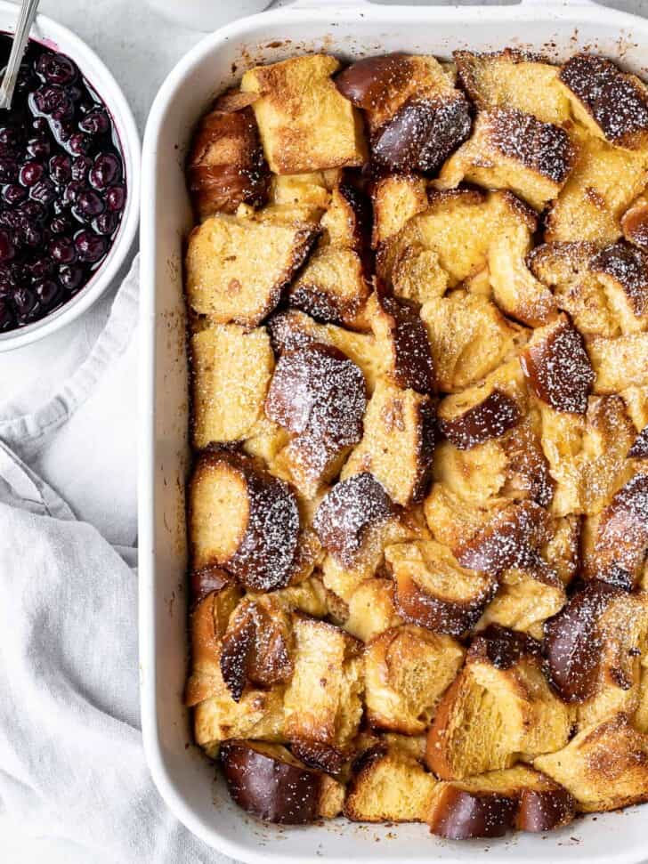 Baked French Toast in baking dish with dusting of icing sugar