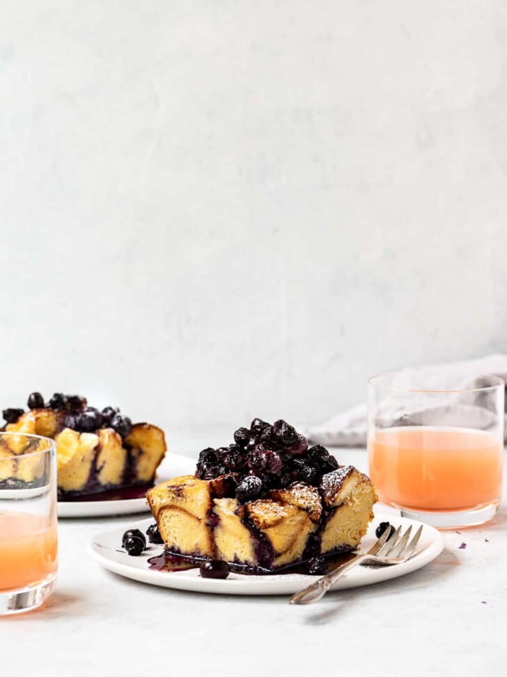baked French toast served on plated and topped with blueberry compote