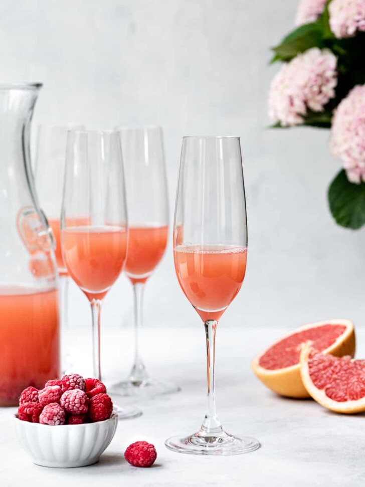 Grapefruit juice poured in tall champagne flutes