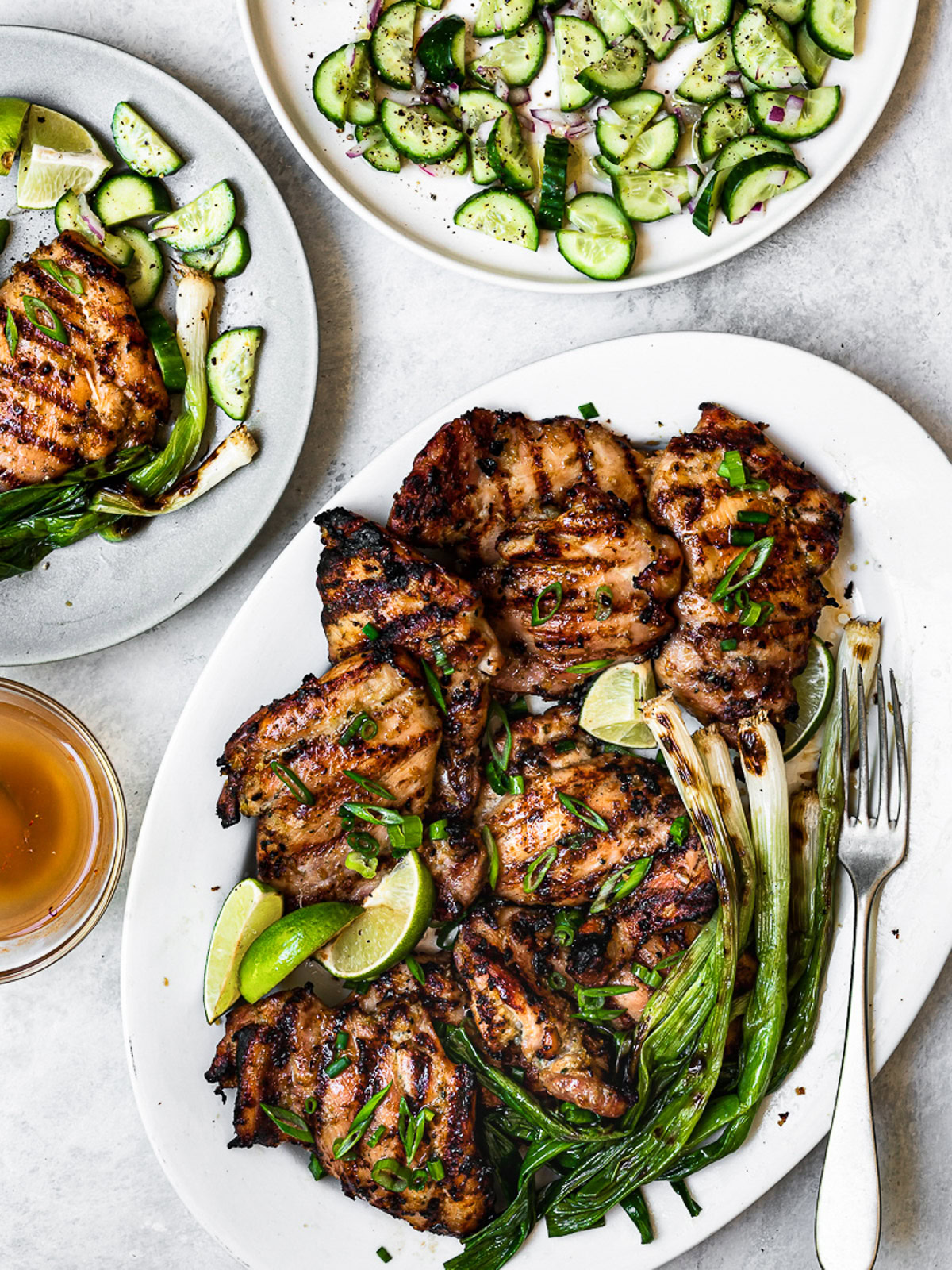 Grilled Lemongrass Chicken on platter with Nuoc Cham and cucumber salad