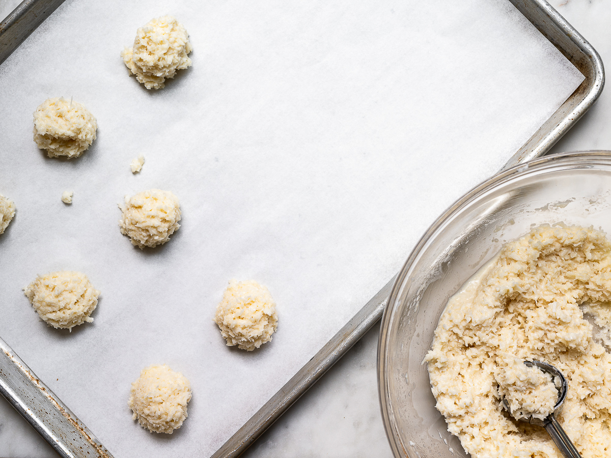 mounds of unbaked macaroons on baking sheet