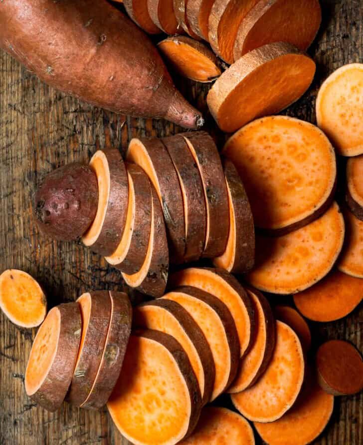 Sweet potatoes sliced on cutting board