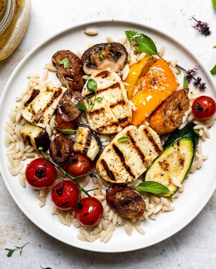 vegetables halloumi and orzo served on a plate 