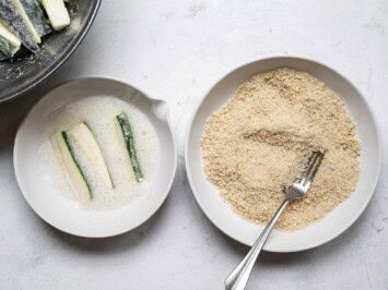 dipping zucchini sticks in egg whites