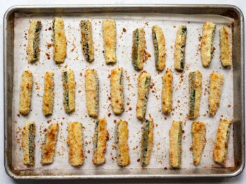 baked breaded zucchini sticks on baking sheet