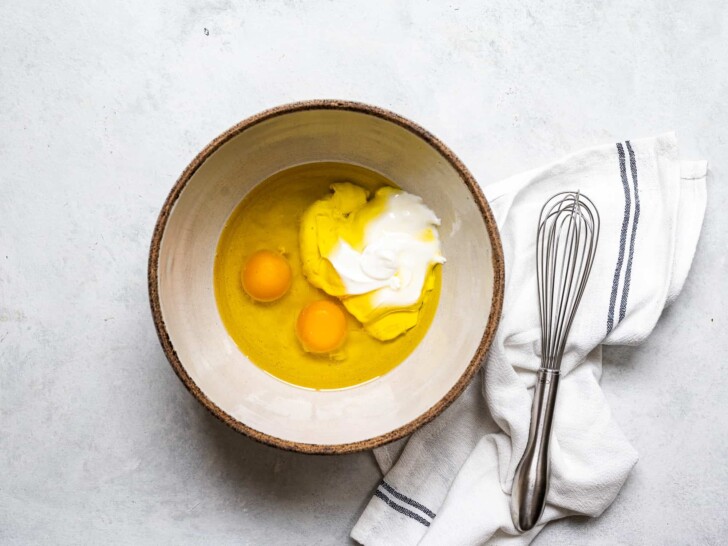 mixing eggs, yogurt and olive in bowl