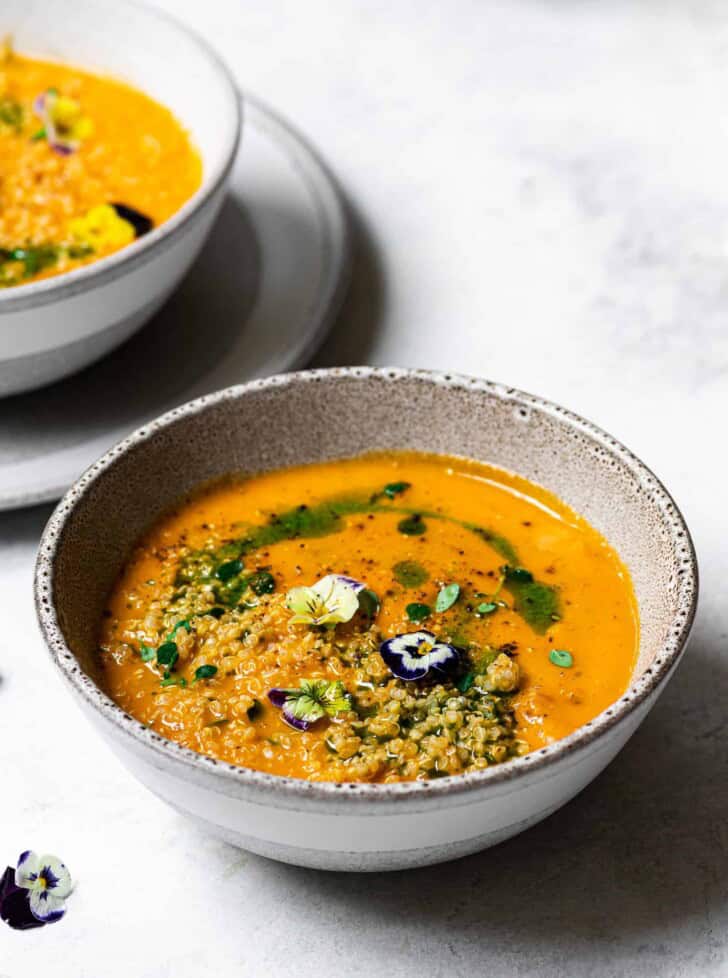 Side view of Creamy Zucchini Tomato Soup in bowls 