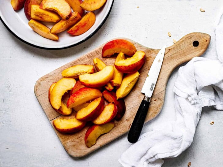 sliced peaches on cutting board