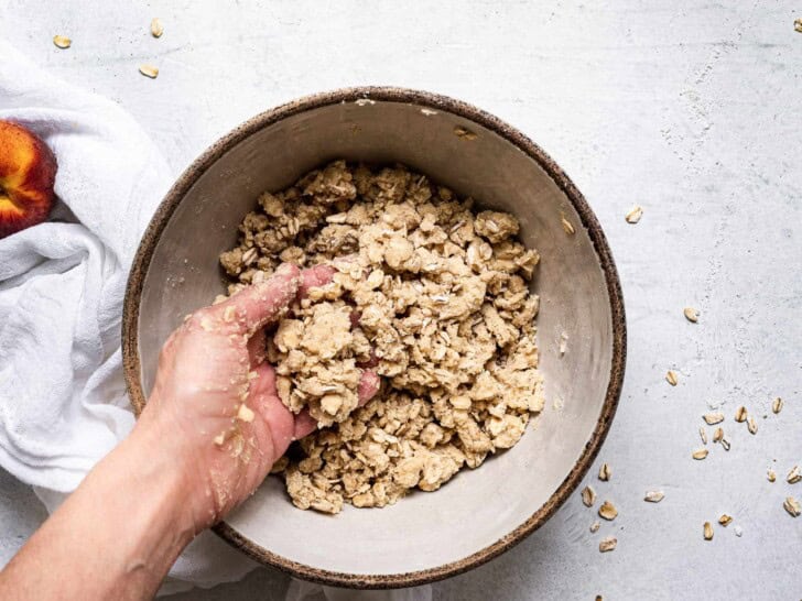 hand mixing topping mixture in bowl