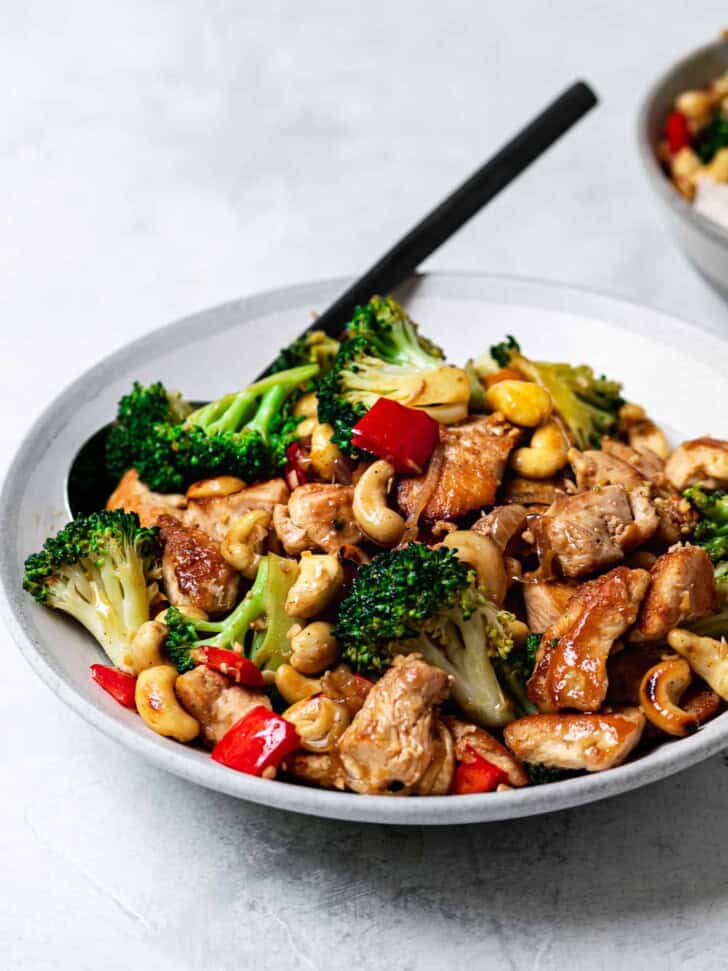 cashew chicken and broccoli served in bowl