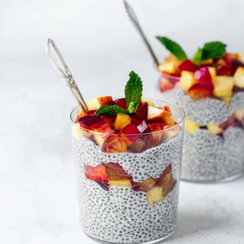 coconut chia pudding topped with fruit in glasses