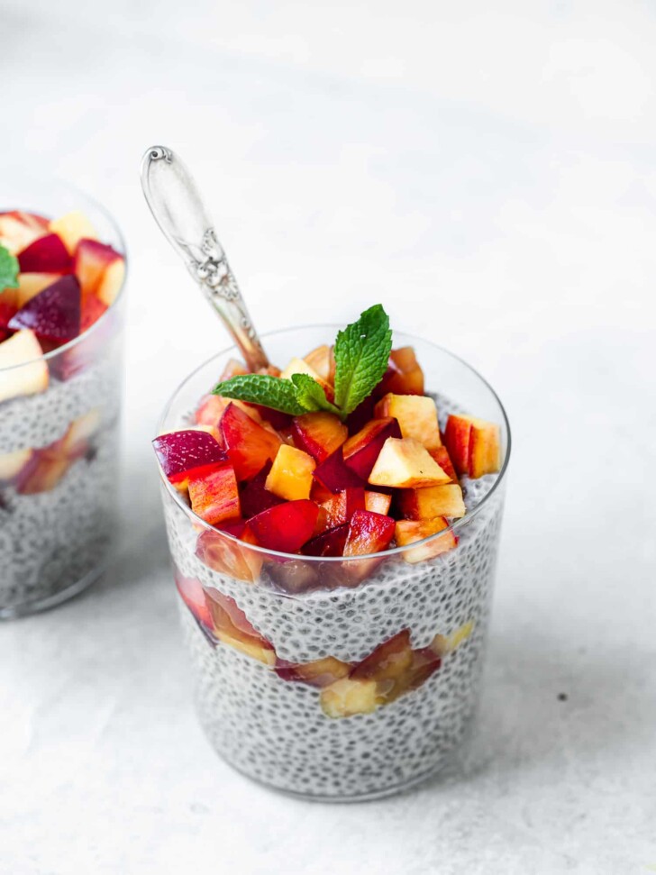 coconut chia pudding topped with fruit in glasses