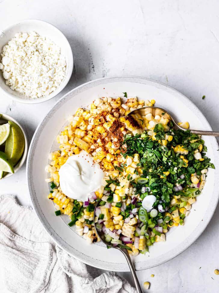 Assembling salad in bowl