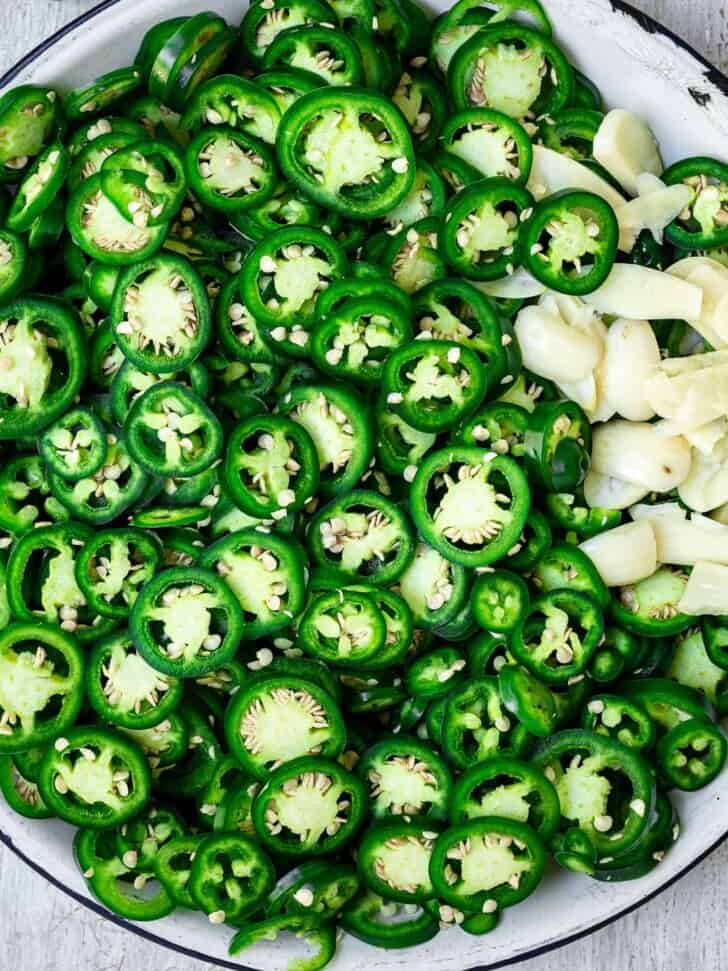 sliced jalapeños on plate with garlic