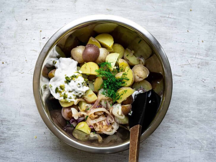 Combining potato salad ingredients in mixing bowl