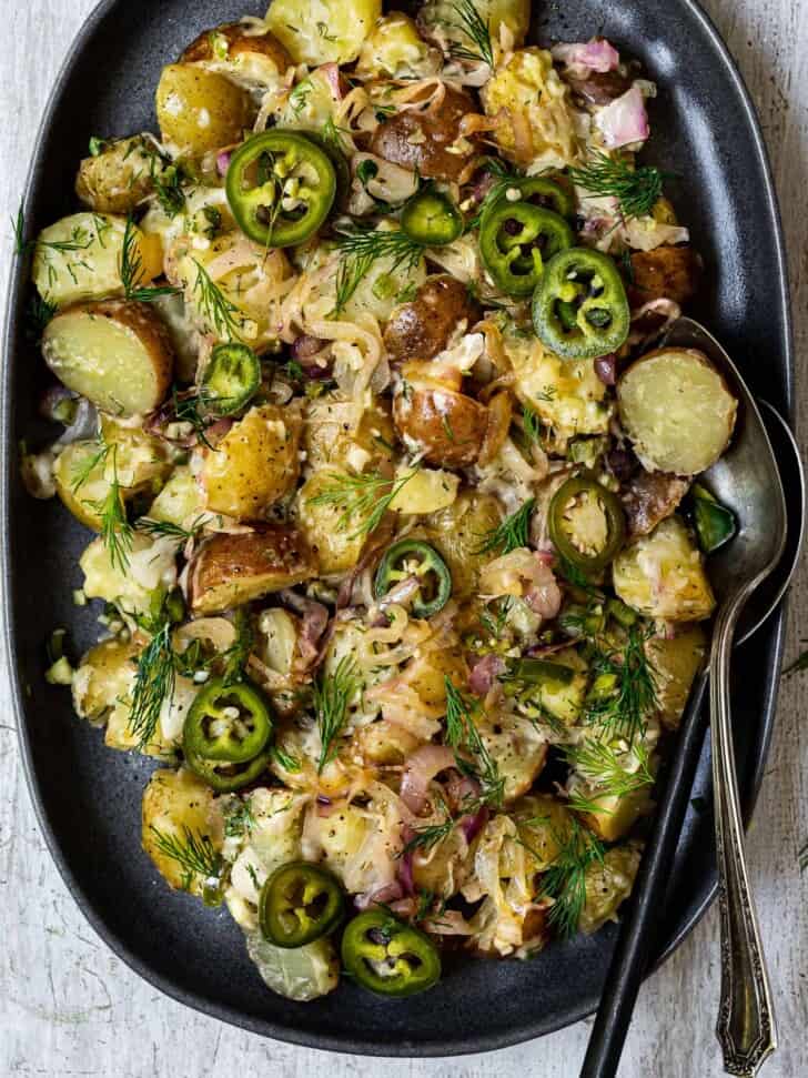 close up of potato salad with caramelized shallots on platter