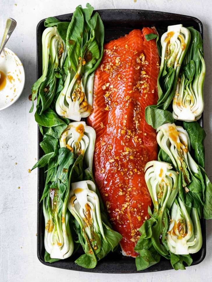 salmon on baking sheet with bok choy