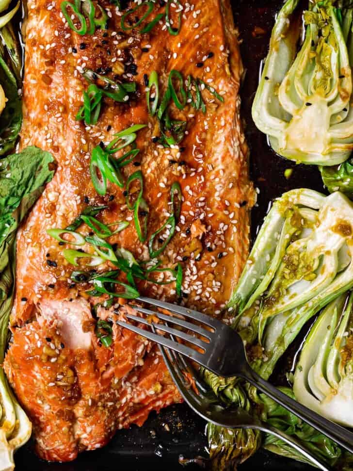 close up of salmon being served with forks