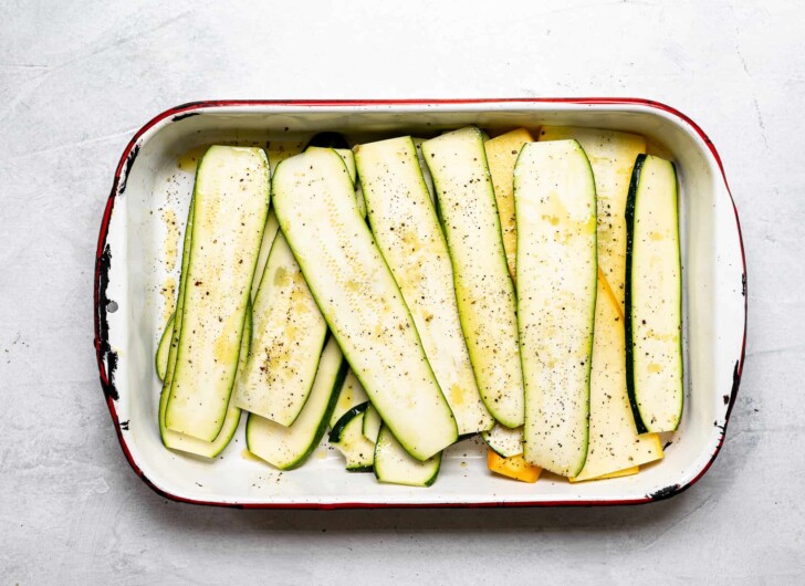 sliced zucchini in pan drizzled with olive oil