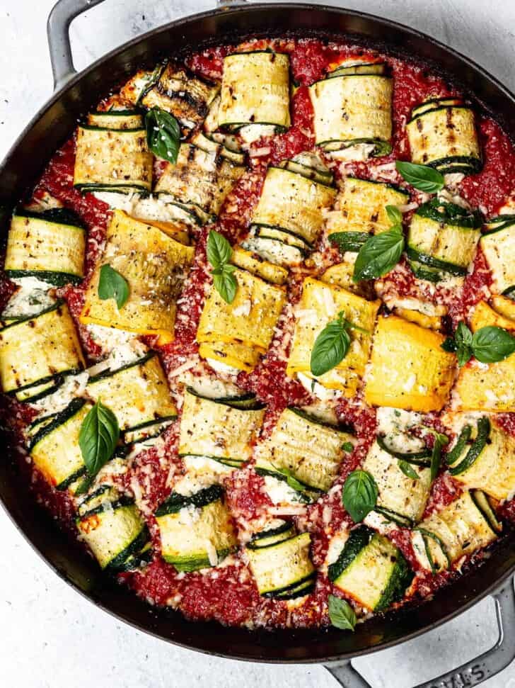 close up of Zucchini involtini in pan with tomato sauce