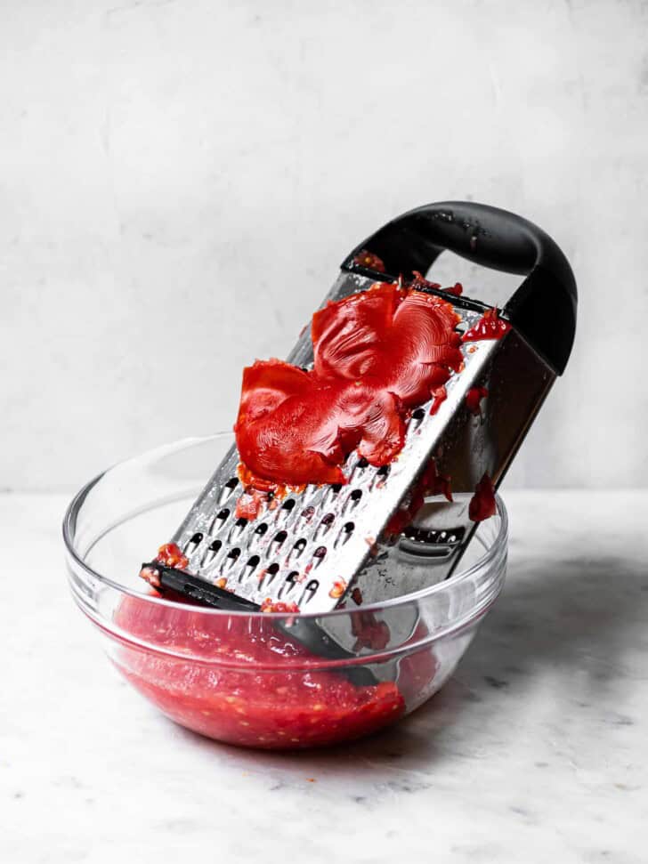 Grating tomatoes on box grater