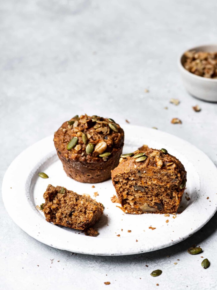 Muffins on plate with walnut dish in background