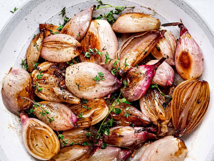 close up of balsamic roasted shallots in bowl