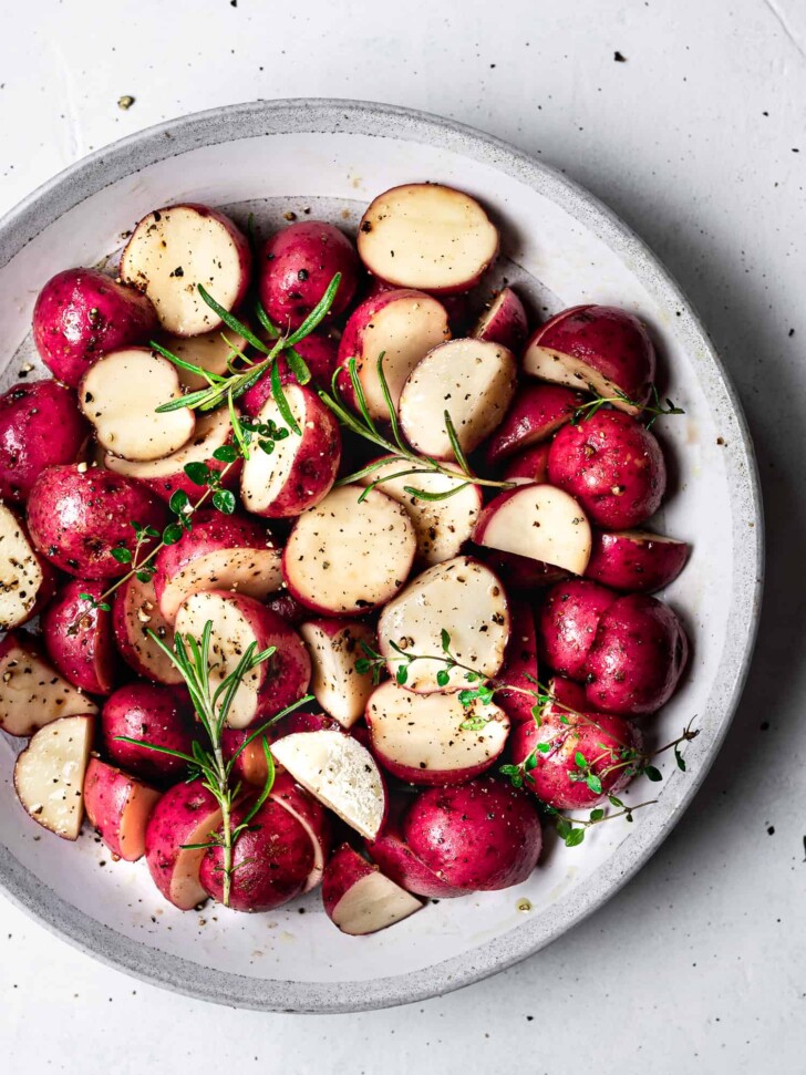 Cut red baby potatoes in bowl