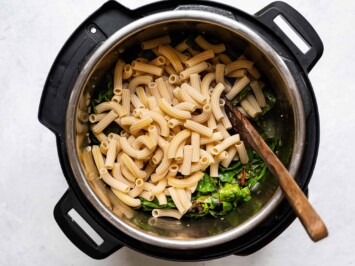 adding dried pasta to the pot