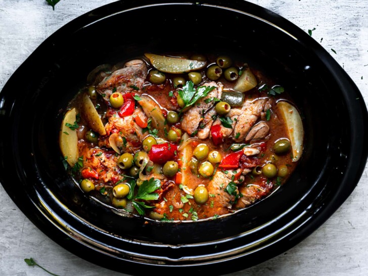 cooked chicken stew with olives in slow cooker