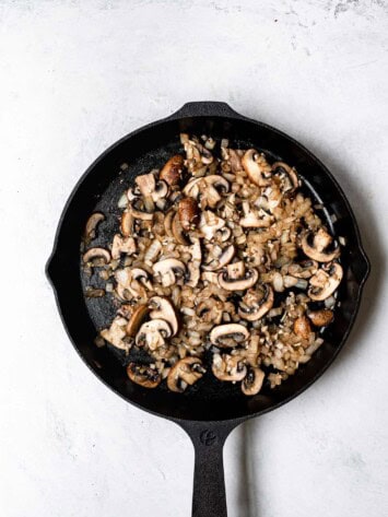 mushrooms and onions cooking in skillet