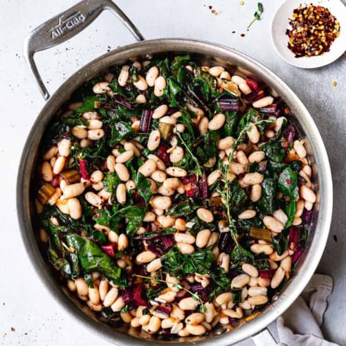 Sautéed Swiss chard with White beans in skillet