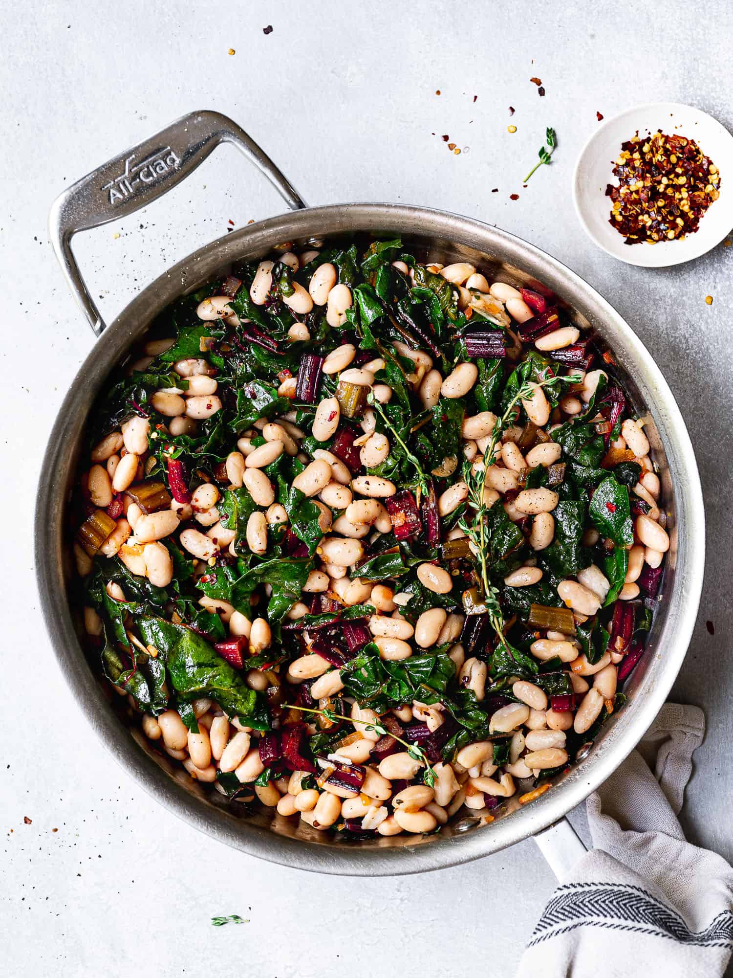 Sautéed Swiss chard with White beans in skillet