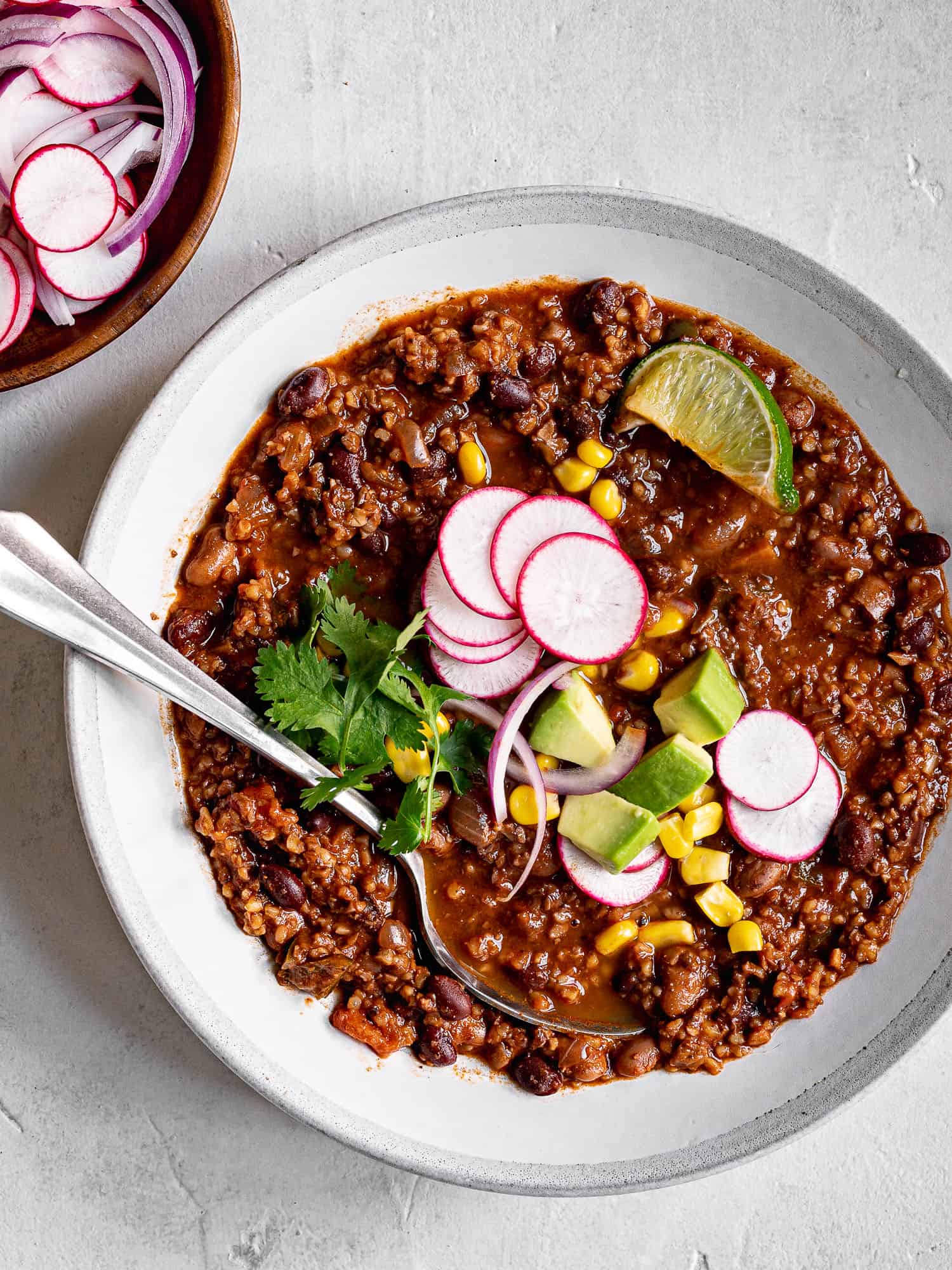 Vegan Chili in a bowl with toppings