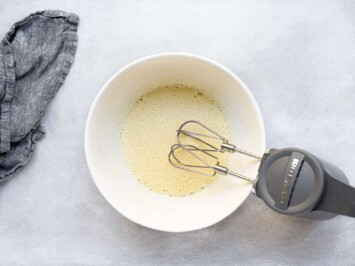 beating eggs and sugar in mixing bowl