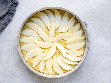 topping unbaked cake with sliced apples