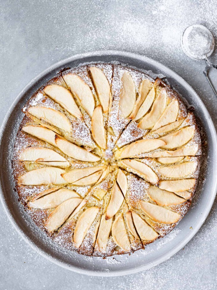 dusting apple cake with icing sugar