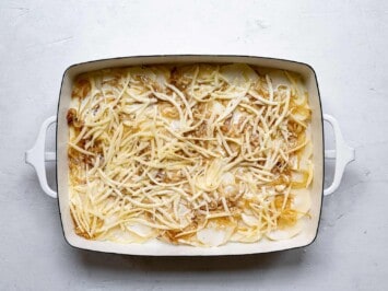 layering cheese on top of potatoes slices