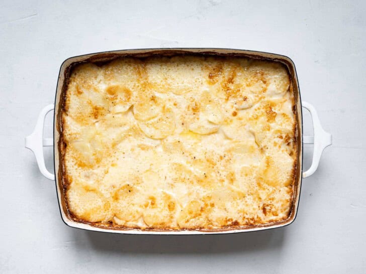 baked Potatoes au gratin with caramelized onions in casserole dish 