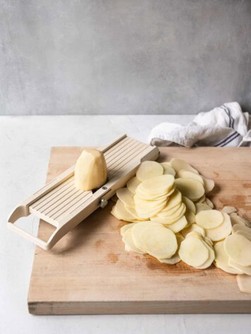 slicing potatoes with mandoline 