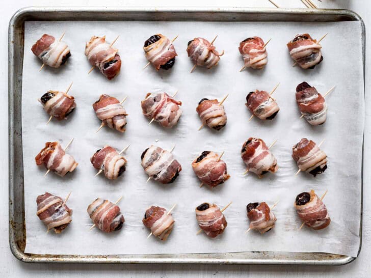 un-baked bacon wrapped dates on baking sheet